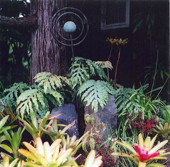 Orbit sculpture embedded in tropical foliage