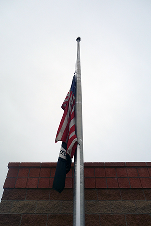 American flag at half mast, deflated